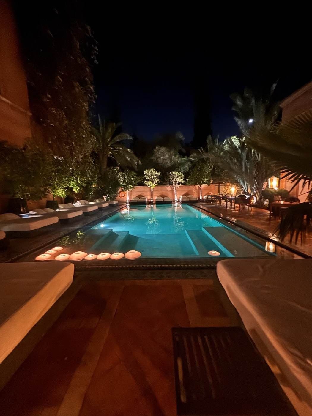 Piscine de riad illuminée à la nuit tombée